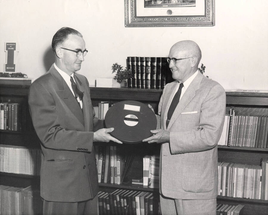 1957 photograph of Gifts. l-r: Elmer Nelson, Idaho First National Bank; President D. R. theophilus. Donor: Publications Dept. [PG1_400-30]