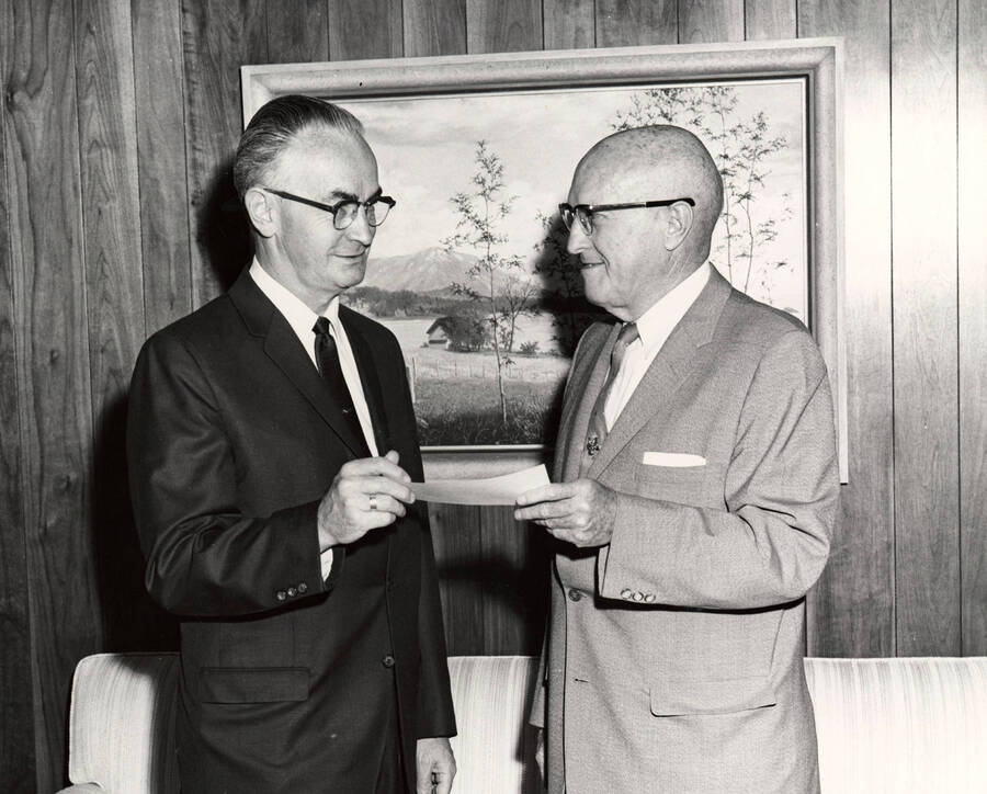1964 photograph of Gifts. l-r: Elmer Nelson, Idaho First National Bank; President D. R. theophilus. Donor: Publications Dept. [PG1_400-32]