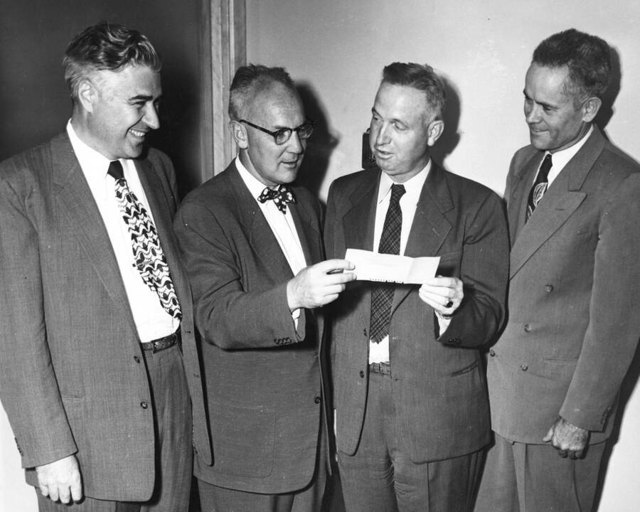 1955 photograph of Gifts. James E. Kraus and Don Marshall accept check from Sears representatives. Donor: Publications Dept. [PG1_400-38]