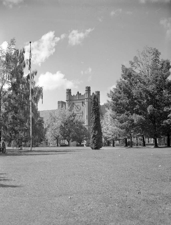 1948 photograph of Administration Building. View of the lawn, with the flag on the left. [PG1_52-140]