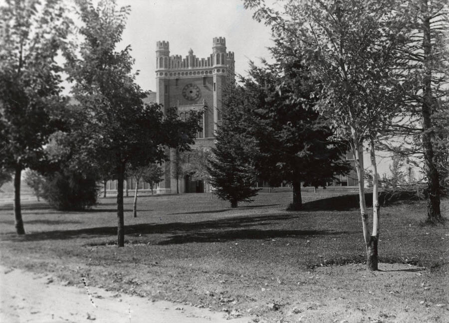 1934 photograph of Administration Building. View of the clock tower between the trees. Donor: Cal Warnick. [PG1_52-154a]