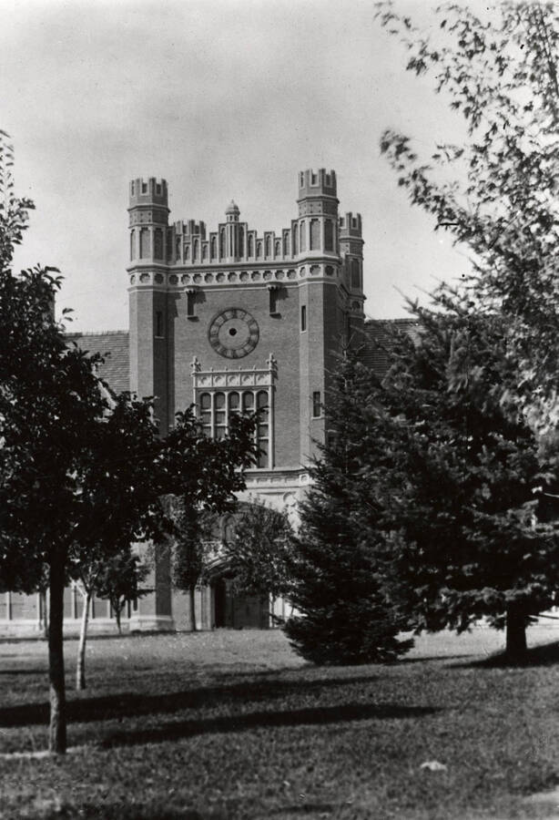 1934 photograph of Administration Building. View of the clock tower between the trees. Donor: Cal Warnick. [PG1_52-154b]