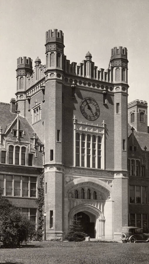 1923 photograph of Administration Building. View of the Administration's clock tower with an automobile in front. [PG1_52-017]