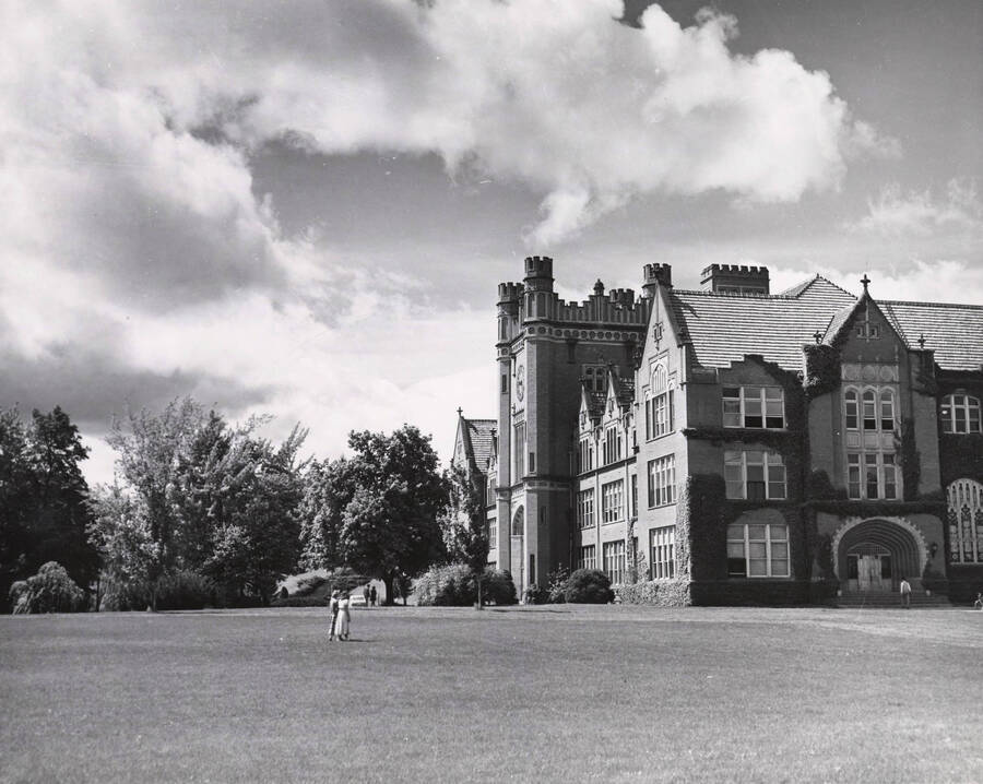 1938 photograph of Administration Building. Students shown walking on the lawn. [PG1_52-050]