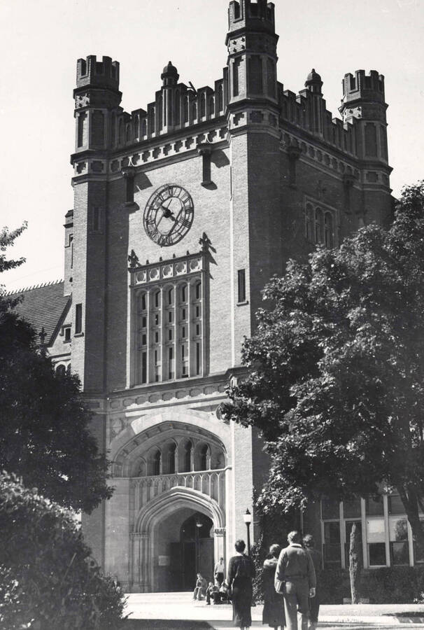 1930 photograph of Administration Building. View of clock tower and students. [PG1_52-053]