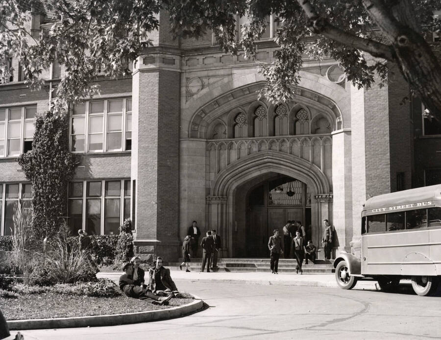 1939 photograph of Administration Building. View of the drive up to the Administration with city bus out front.[PG1_52-066]