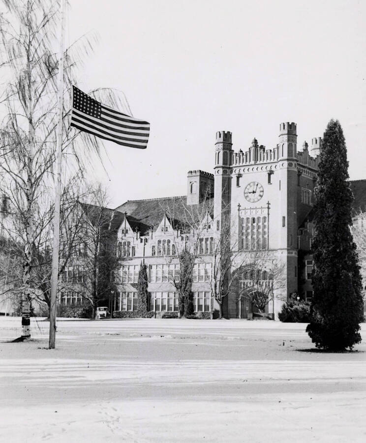 1940 photograph of Administration Building. Flag hung at half mast. [PG1_52-069]