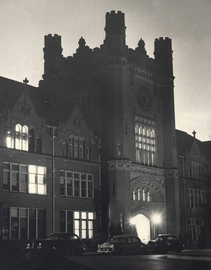 1950 photograph of Administration Building. View of the drive with automobiles at night. Donor: Publications Dept. [PG1_52-092]