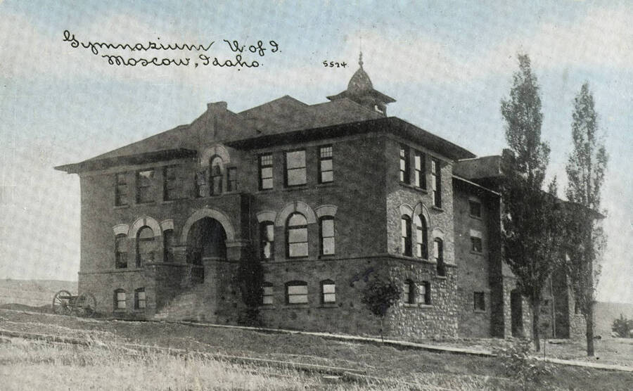 1907 photograph of Gymnasium. View of the cannon out front. [PG1_54-07]