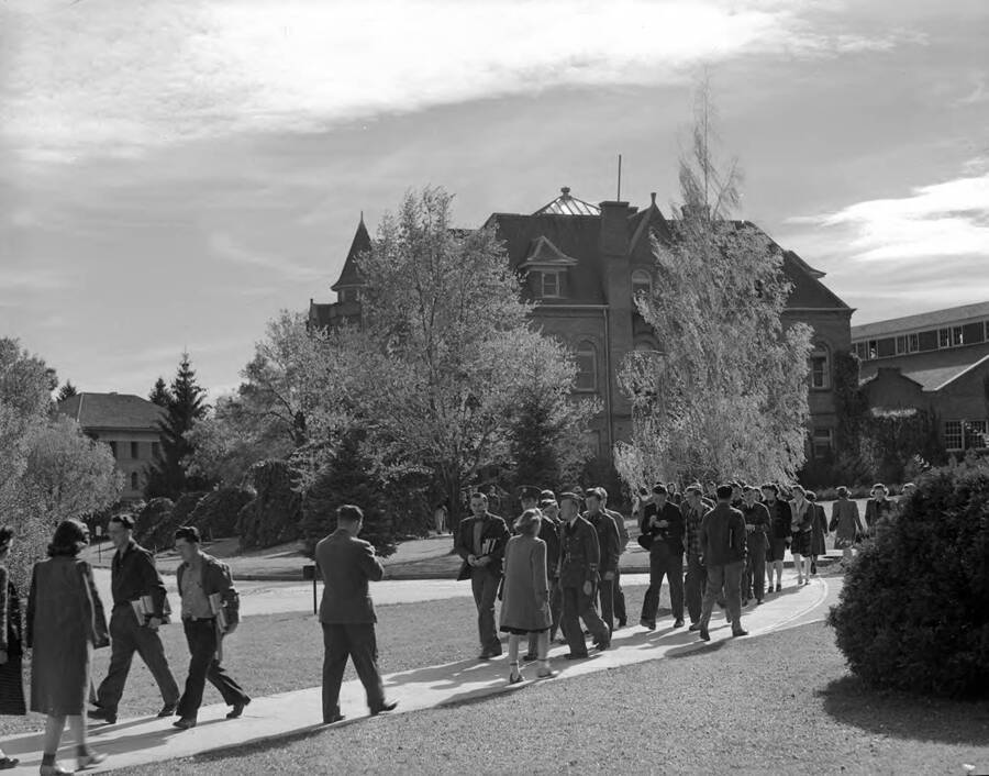 1940 photograph of Engineering Building. View of students walking to class. [PG1_56-36]