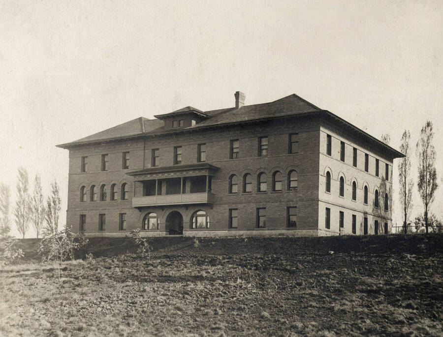 1901 photograph of Ridenbaugh Hall. View of the poplar trees in the back. [PG1_58-01]