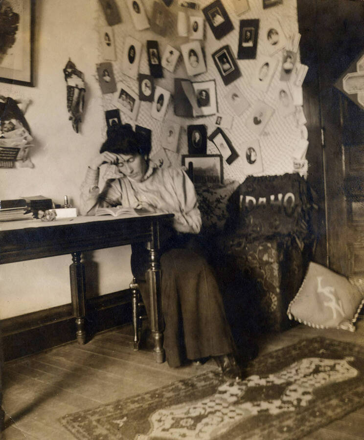 1909 photograph of Ridenbaugh Hall. Myrtle Hitt studying. [PG1_58-24b]