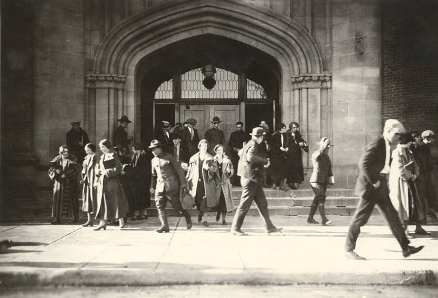 1930 photograph of University of Idaho campus scene. View of students and soldiers at the building entrance. [PG1_006-43]