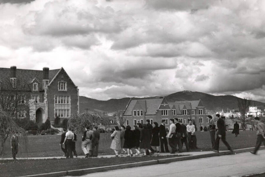 1940 photograph of University of Idaho campus scene. View of students walking to class. [PG1_006-44]