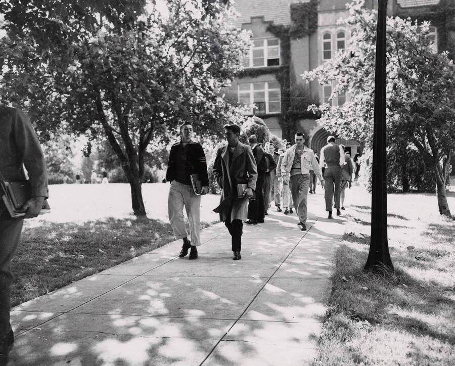 1941 photograph of University of Idaho campus scenery. Students showed walking to class. Donor: Publications Dept. [PG1_006-07]