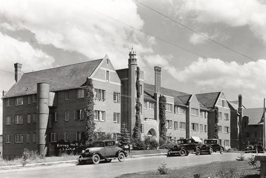 1930 photograph of Forney Hall. Street with automobiles out front. [PG1_60-16]
