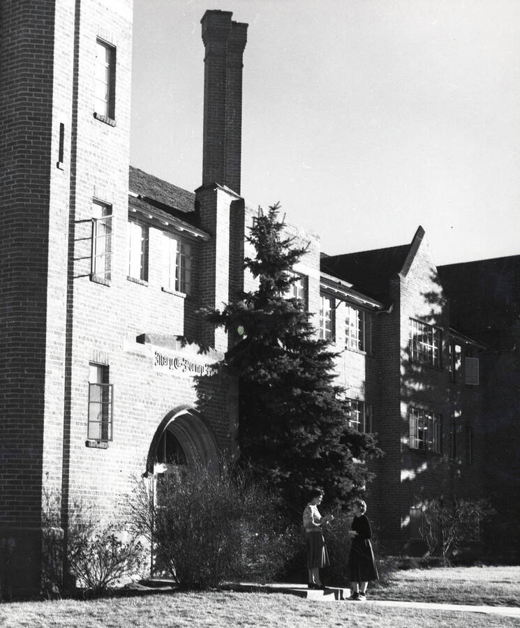 1940 photograph of Forney Hall. View of residents next to building entrance. Donor: Publications Dept. [PG1_60-21]