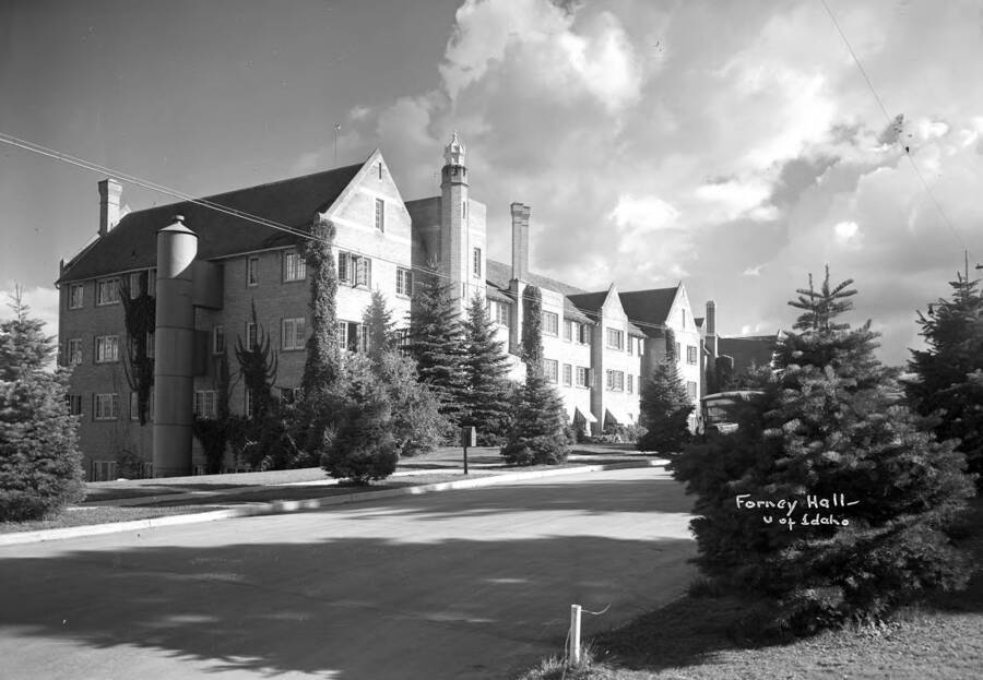 1930 photograph of Forney Hall. View of the street and the landscaping. [PG1_60-26]