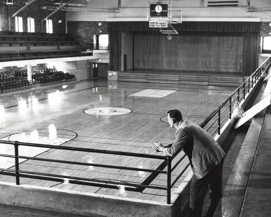 1960 photograph of Memorial Gymnasium. Joe Cipriano looks at his basketball court. [PG1_61-18]