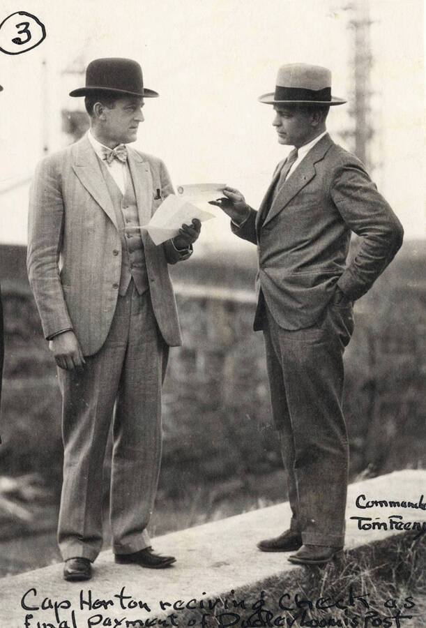 1927 photograph of Memorial Gymnasium. Captain Horton receives check as final payment from Commander Tom Feeny. [PG1_61-25]