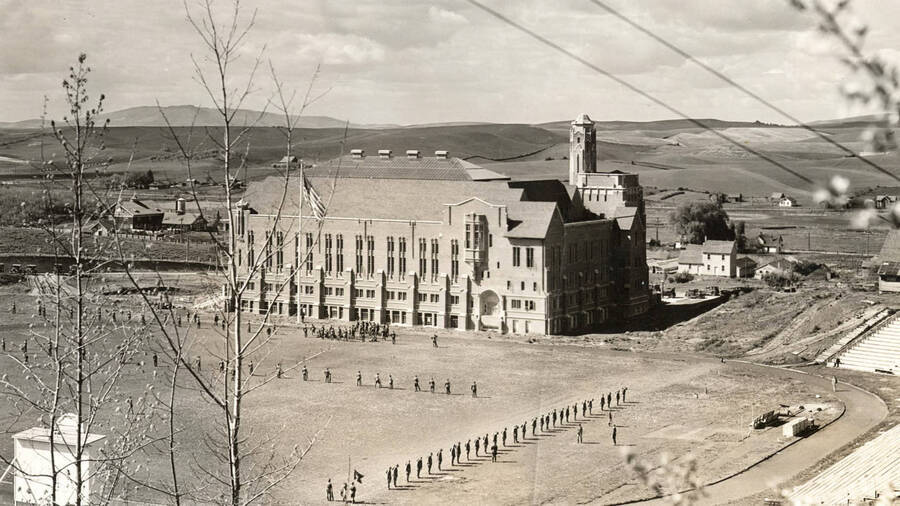 1928 photograph of Memorial Gymnasium. View from the top of the hill of military formations. [PG1_61-27]