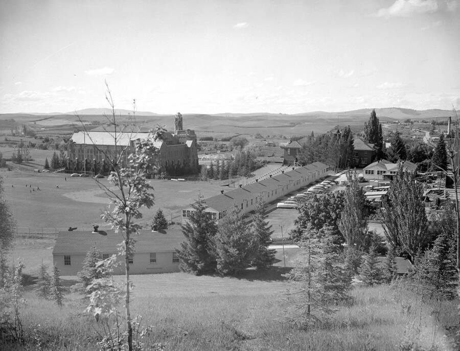 1930 photograph of Memorial Gymnasium. View from the top of the hill with fields in the background. [PG1_61-48]