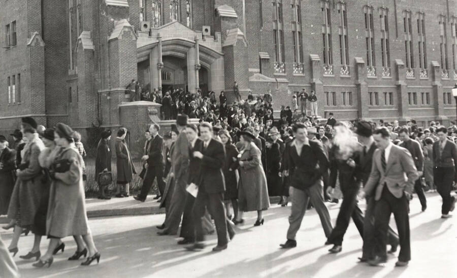 1940 photograph of University of Idaho campus scene. View of students walking out of Memorial Gymnasium. [PG1_61-54]