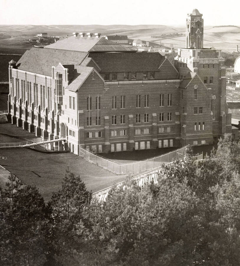 1930 photograph of Memorial Gymnasium. View of the southeast corner with farms in the background. [PG1_61-07]