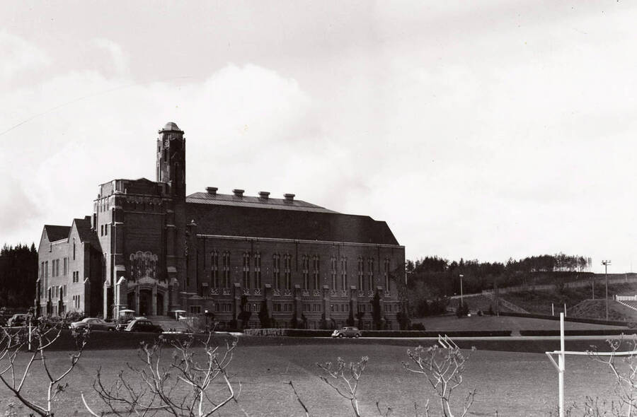 1930 photograph of Memorial Gymnasium. View of the main entrance with automobiles in front. [PG1_61-08]