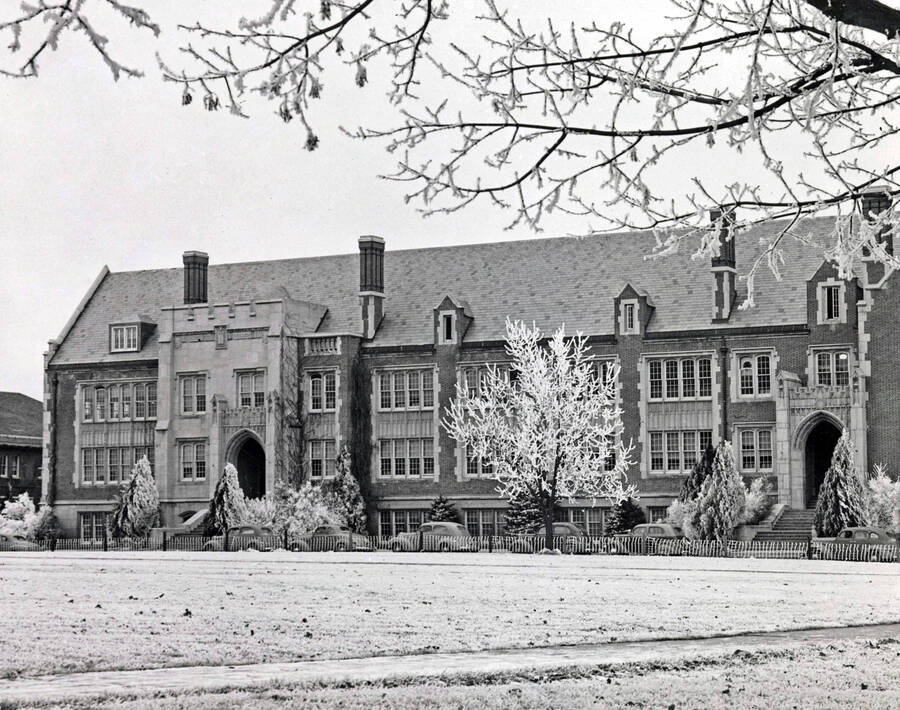 1945 photograph of Science Hall Renamed Life Sciences Building in 1964. Winter scene framed by tree. [PG1_067-34]