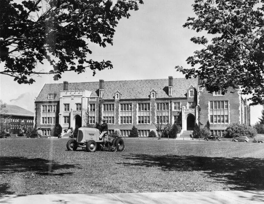 1923 photograph of Science Hall Renamed Life Sciences Building in 1964. View of worker on a riding mower. [PG1_067-70]