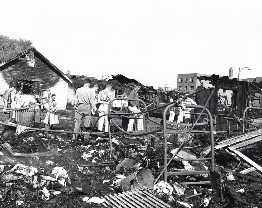 1958 photograph of Campus Club. Students survey the aftermath of the fire. [PG1_072-04]