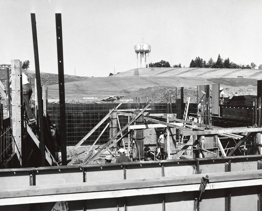 1958 photograph of Campus Club. View of construction with the water tower in the background. [PG1_073-04]