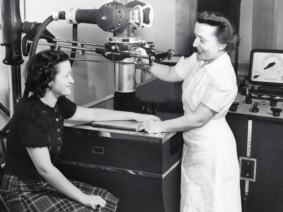1941 photograph of Infirmary. Nurse x-rays student's arm. [PG1_074-15]