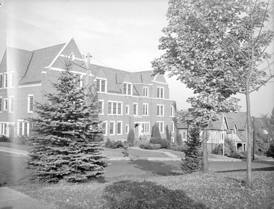 1930 photograph of Infirmary. University Avenue view shows a postman on rounds. [PG1_074-30]