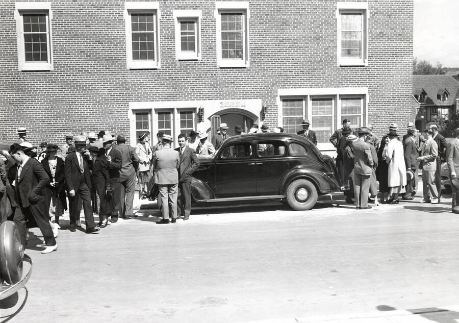 1937 photograph of Infirmary. Automobile parked in front with people getting ready to attend the dedication. [PG1_074-05]