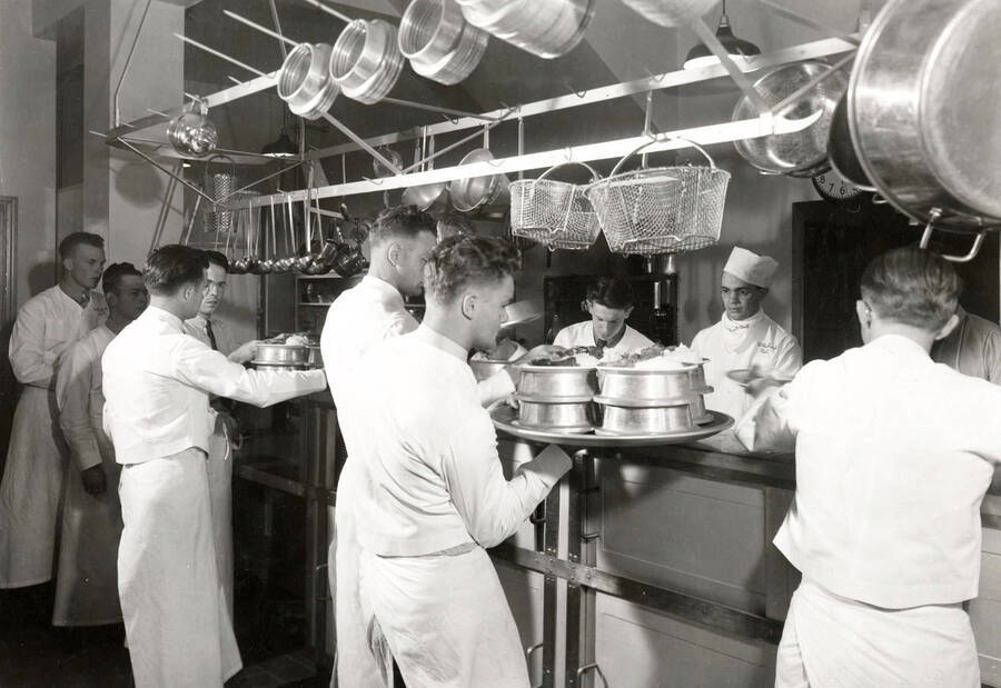 1936 photograph of Willis Sweet Hall. View of the kitchen and staff. [PG1_075-02]