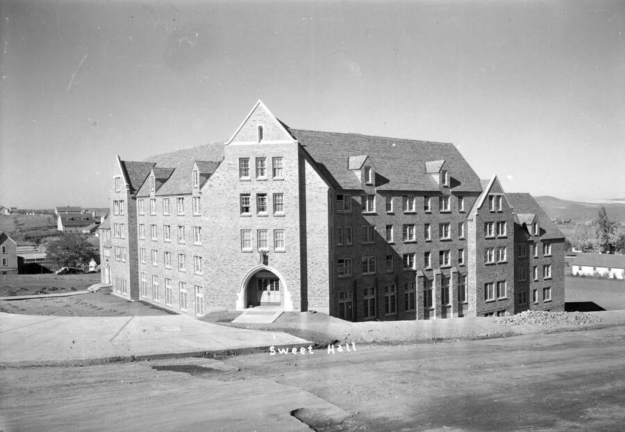 1937 photograph of Willis Sweet Hall. View from the corner, farms may be seen in the background. [PG1_075-07]