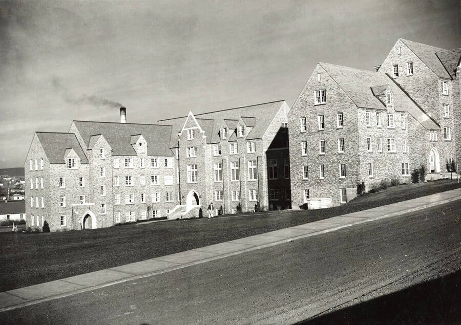 1939 photograph of Chrisman Hall. View from the street with student walking to class. [PG1_076-05]