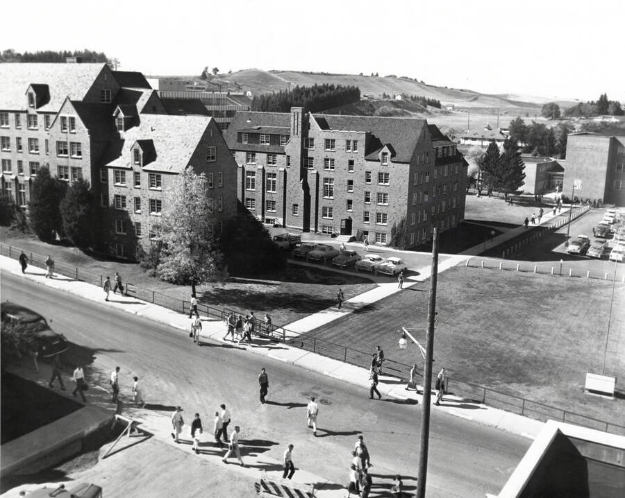 1960 photograph of Chrisman Hall. View of students walking to classes and blocked streets. [PG1_076-09]