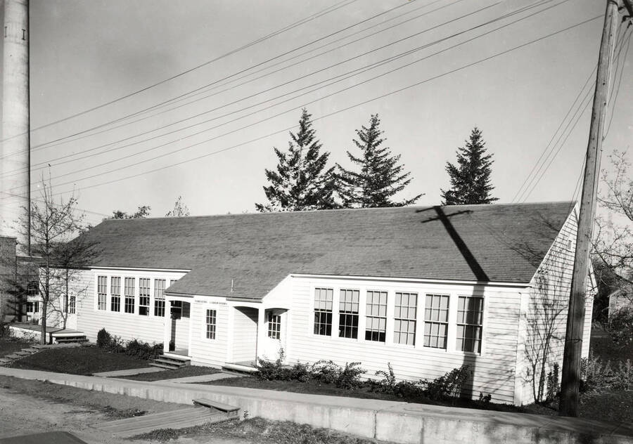 1936 photograph of Forestry Laboratory. Power plant stack is visible on the left. [PG1_078-01]
