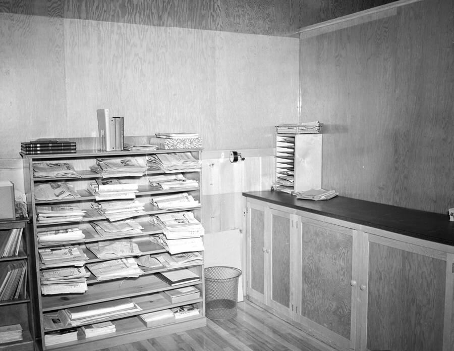 1935 photograph of University Classroom Building. View of the newspaper rack in the Journalism Office. [PG1_082-6c]