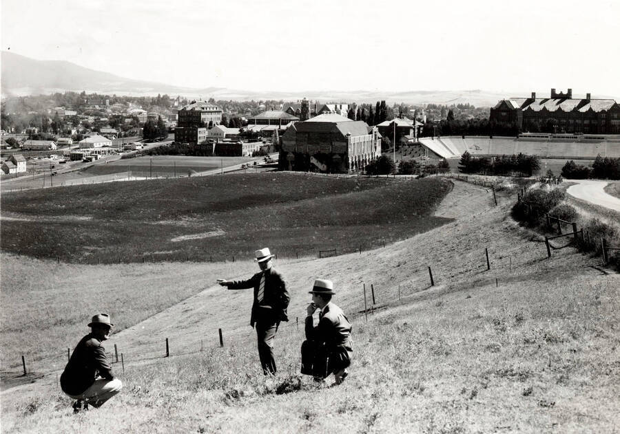 1936 photograph of Neale Stadium Cap Horton, Ted Bank, and Rafe Gibbs examine site. [PG1_085-02]