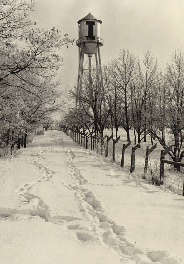 1928 photograph of I Tower. View of the fence and tracks in the snow. [PG1_088-02]