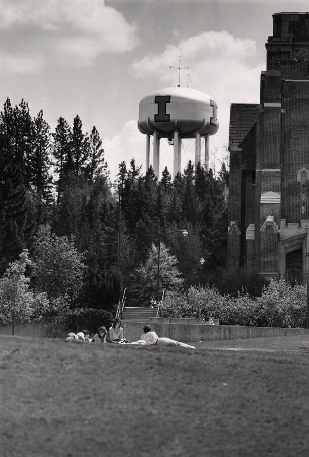 1972 photograph of I tank. Students are lounging on the lawn by Memorial Gym. [PG1_089-06]