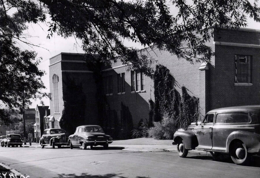 1948 photograph of Dairy Science Building. View looking west from Idaho, automobiles parked in front. [PG1_092-10]