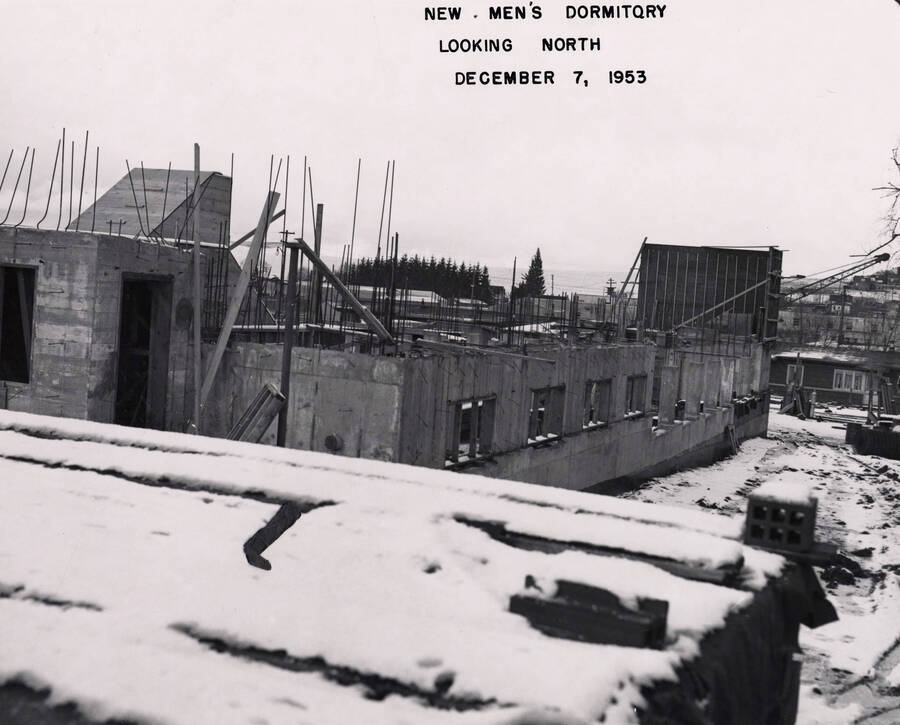 December 7, 1953 photograph of Gault Hall under construction. Snow covers the scene. [PG1_095-11b]