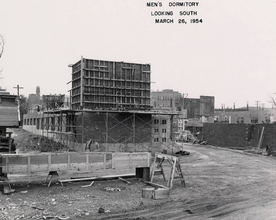 March 26, 1954 photograph of Gault Hall under construction. Memorial Gym in the background. [PG1_095-13c]