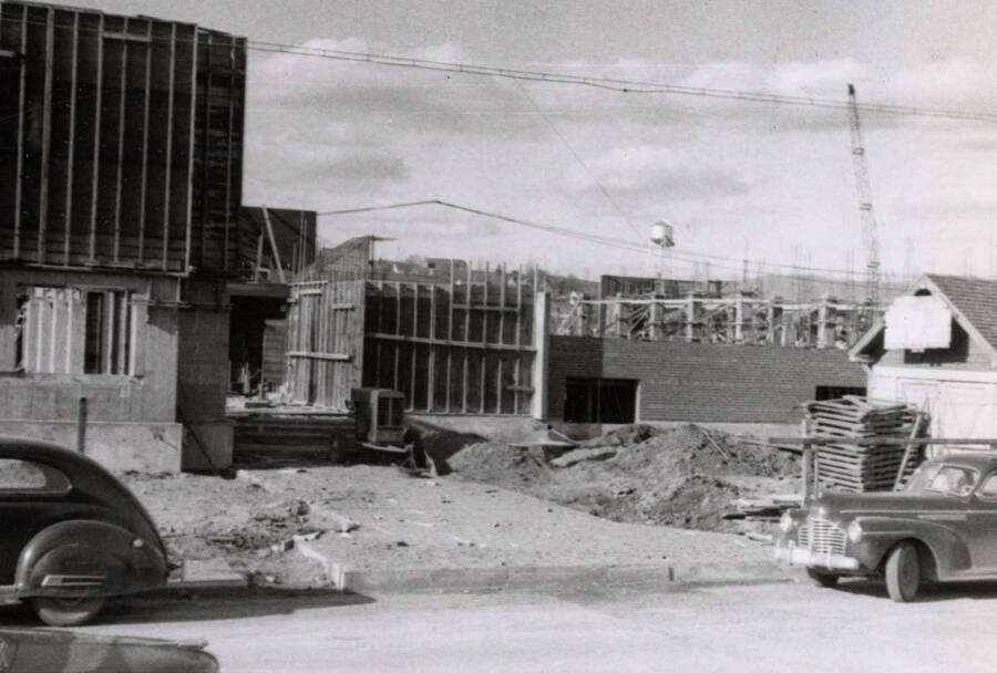 1954 photograph of Gault Hall under construction. Automobiles in foreground. Donor: Maurice Johnson. [PG1_095-20a]