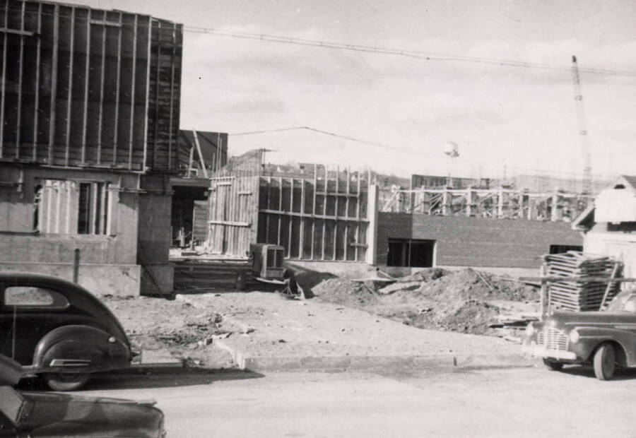 1954 photograph of Gault Hall under construction. Automobiles in foreground. Donor: Maurice Johnson. [PG1_095-20b]